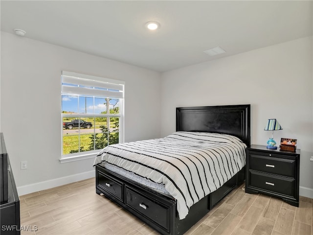 2405 Nelson Rd N, Cape Coral, FL 33993 - bedroom featuring baseboards and light wood-style flooring