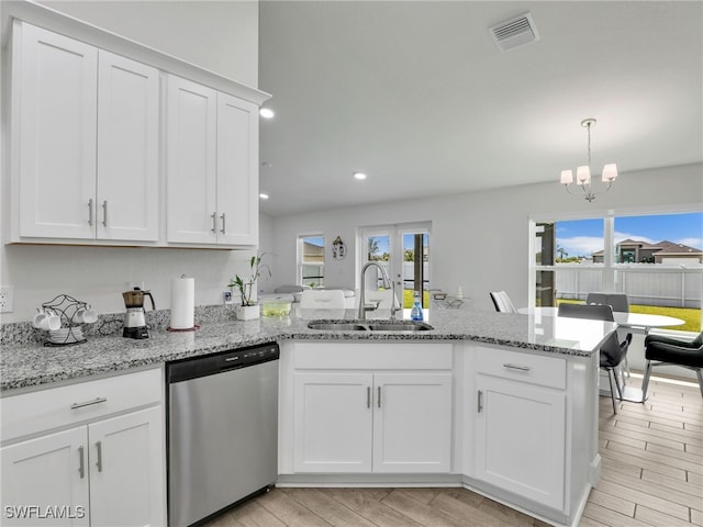 2405 Nelson Rd N, Cape Coral, FL 33993 - kitchen with dishwasher, a peninsula, white cabinetry, a chandelier, and recessed lighting