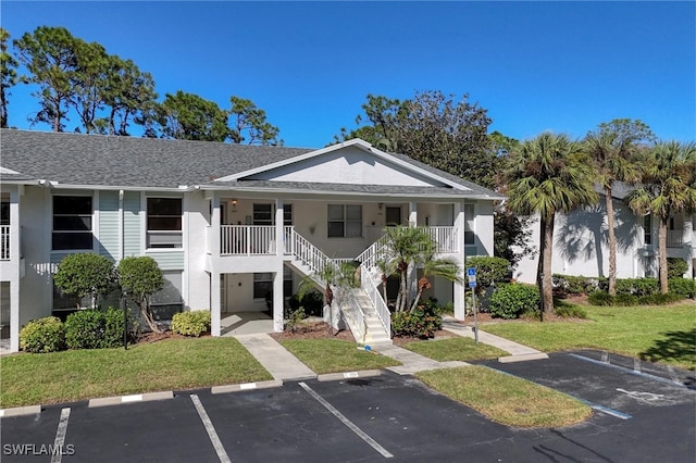 1140 Sarah Jean Cir Unit C-205, Naples, FL 34110 - view of property featuring stairs and uncovered parking