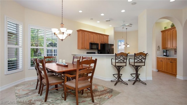 20029 Saraceno Dr, Estero, FL 33928 - dining room with a chandelier, healthy amount of natural light, recessed lighting, ceiling fan, and arched walkways