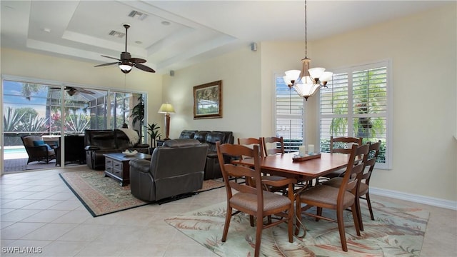 20029 Saraceno Dr, Estero, FL 33928 - dining area featuring a tray ceiling, a chandelier, a ceiling fan, and light tile patterned floors