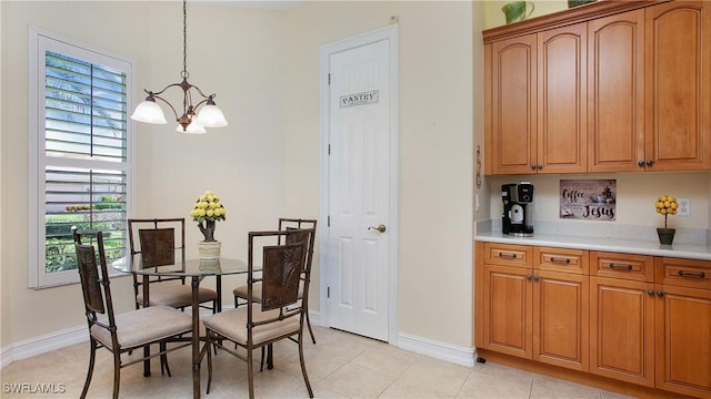 20029 Saraceno Dr, Estero, FL 33928 - dining area featuring a chandelier, healthy amount of natural light, and light tile patterned floors