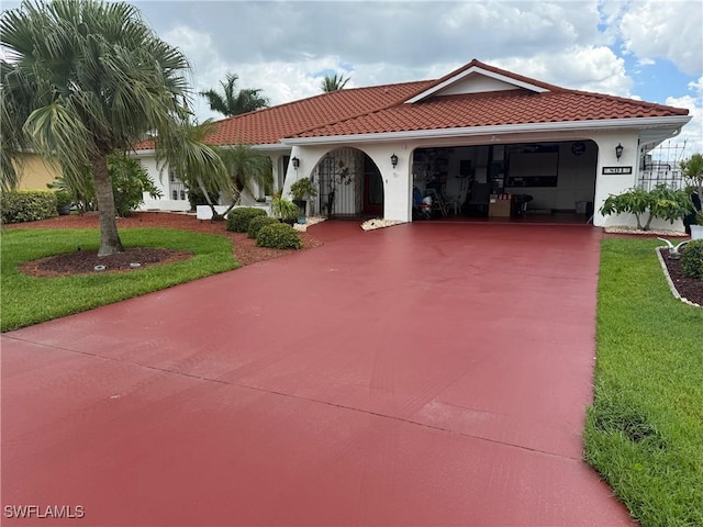 804 SW Santa Barbara Pl, Cape Coral, FL 33991 - mediterranean / spanish-style home with concrete driveway, stucco siding, a front lawn, and an attached garage
