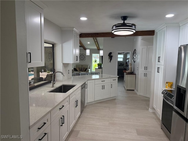 804 SW Santa Barbara Pl, Cape Coral, FL 33991 - kitchen featuring stainless steel appliances, white cabinetry, light wood-style floors, light stone counters, and beamed ceiling