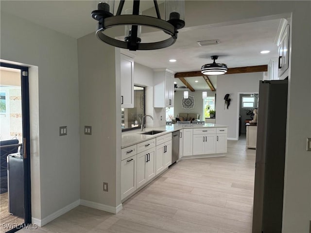 804 SW Santa Barbara Pl, Cape Coral, FL 33991 - kitchen featuring appliances with stainless steel finishes, white cabinetry, a peninsula, light wood-style floors, and beamed ceiling