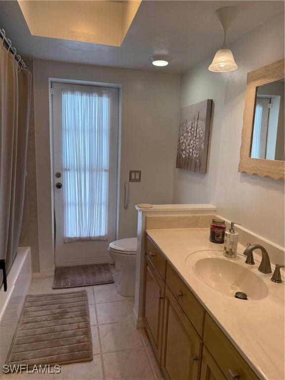 804 SW Santa Barbara Pl, Cape Coral, FL 33991 - bathroom with vanity, tile patterned floors, and shower / bath combo with shower curtain