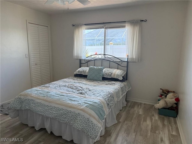 804 SW Santa Barbara Pl, Cape Coral, FL 33991 - bedroom with wood finished floors, a closet, and ceiling fan