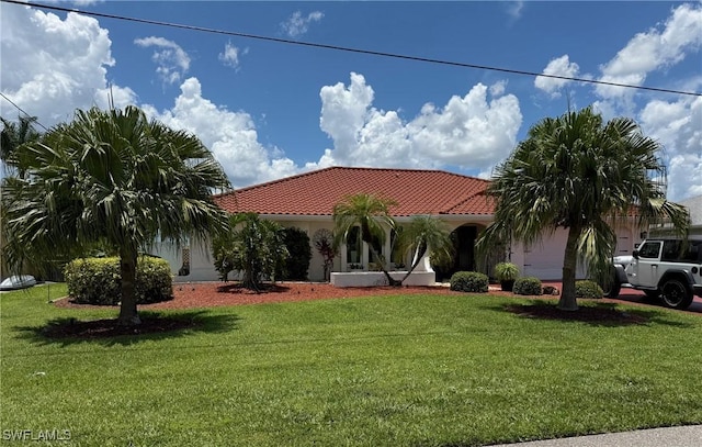 804 SW Santa Barbara Pl, Cape Coral, FL 33991 - mediterranean / spanish house featuring a tile roof, a front lawn, an attached garage, and stucco siding