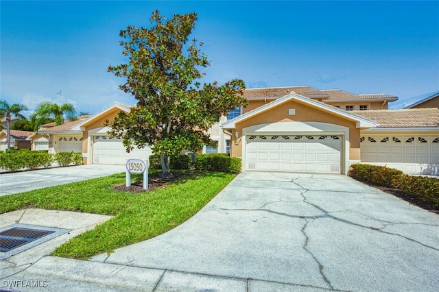 15050 Lakeside View Dr Unit 1003, Fort Myers, FL 33919 - view of front of home featuring driveway, stucco siding, and a front yard