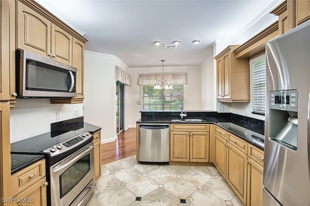 15050 Lakeside View Dr Unit 1003, Fort Myers, FL 33919 - kitchen featuring stainless steel appliances, a chandelier, a peninsula, hanging light fixtures, and crown molding