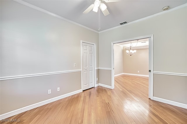 15050 Lakeside View Dr Unit 1003, Fort Myers, FL 33919 - empty room with a smoke detector, light wood-style flooring, a ceiling fan, a chandelier, and ornamental molding