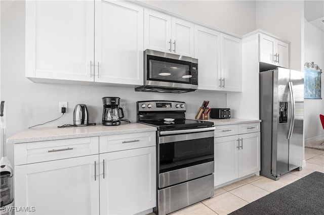 2502 SW 17th Ave, Cape Coral, FL 33914 - kitchen featuring stainless steel appliances, white cabinets, and light tile patterned floors