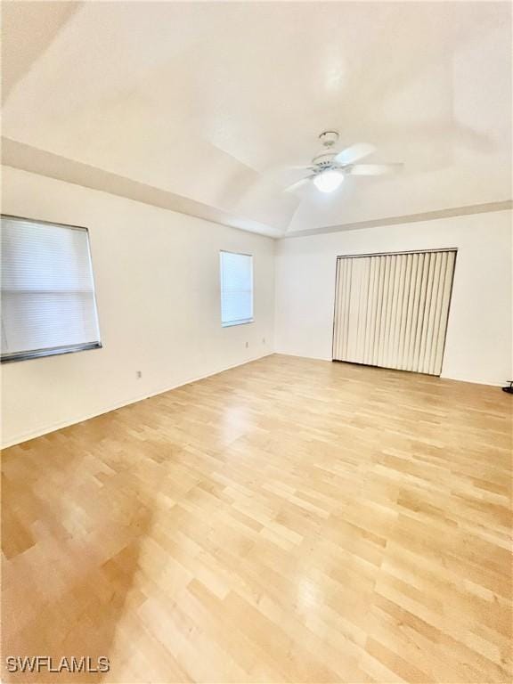 50 24th Ave NW, Naples, FL 34120 - spare room with a ceiling fan, light wood-type flooring, and vaulted ceiling