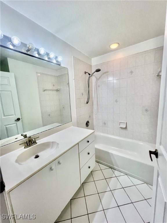 50 24th Ave NW, Naples, FL 34120 - bathroom featuring tile patterned flooring, vanity, and shower / tub combination