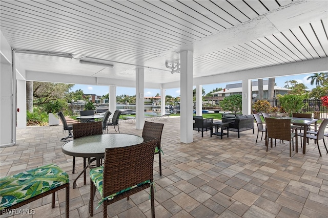 1666 Osprey Ave Unit 106, Naples, FL 34102 - view of patio / terrace with outdoor dining space and an outdoor hangout area