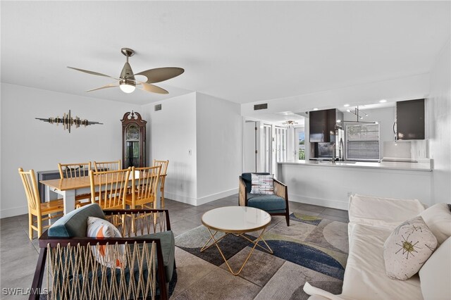 1666 Osprey Ave Unit 106, Naples, FL 34102 - living room with a ceiling fan and baseboards