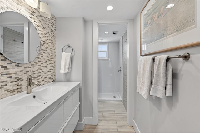 1666 Osprey Ave Unit 106, Naples, FL 34102 - bathroom featuring tasteful backsplash, vanity, a shower stall, and recessed lighting