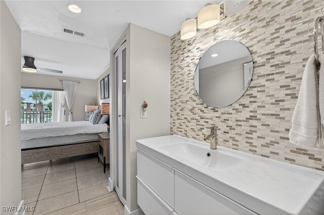 1666 Osprey Ave Unit 106, Naples, FL 34102 - bathroom with connected bathroom, vanity, and a ceiling fan