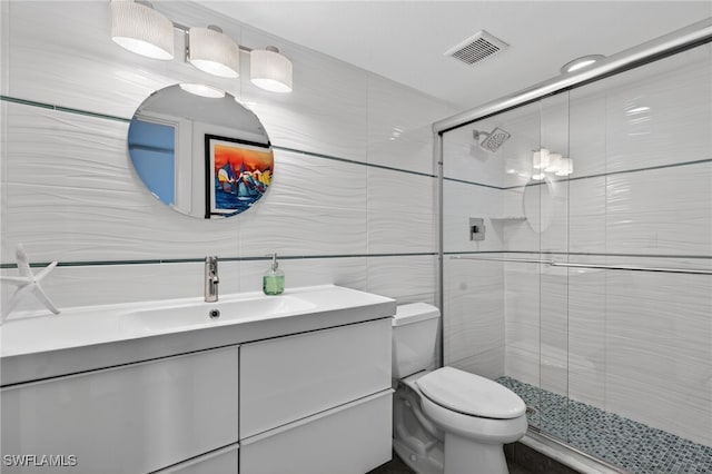 1666 Osprey Ave Unit 106, Naples, FL 34102 - full bathroom with tile walls, vanity, and a shower stall
