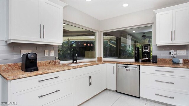 5961 Sea Grass Ln, Naples, FL 34116 - kitchen with stainless steel dishwasher, backsplash, a ceiling fan, white cabinetry, and light stone countertops