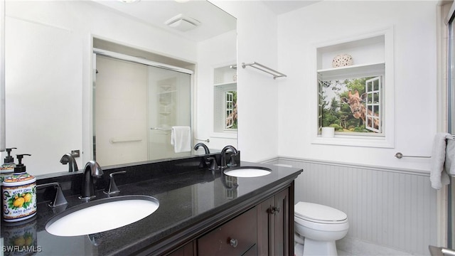 5961 Sea Grass Ln, Naples, FL 34116 - bathroom with a wainscoted wall, double vanity, healthy amount of natural light, and a shower with shower door