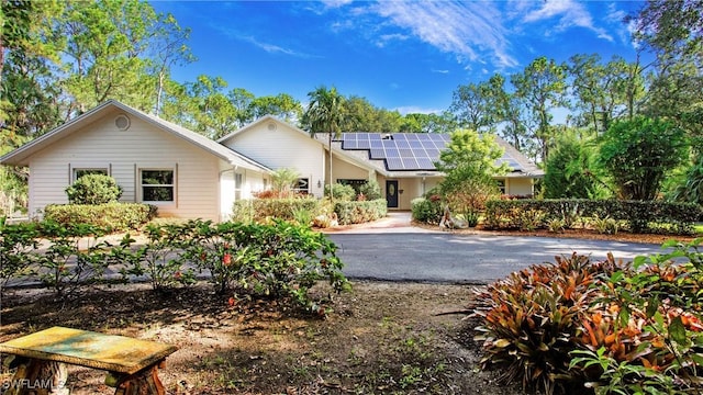 5961 Sea Grass Ln, Naples, FL 34116 - single story home with solar panels and driveway