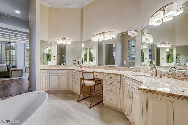 9691 Monteverdi Way, Fort Myers, FL 33912 - full bath featuring a towering ceiling, a soaking tub, ornamental molding, vanity, and tile patterned floors