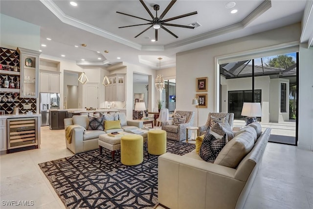 9691 Monteverdi Way, Fort Myers, FL 33912 - living room featuring beverage cooler, a tray ceiling, crown molding, recessed lighting, and a ceiling fan