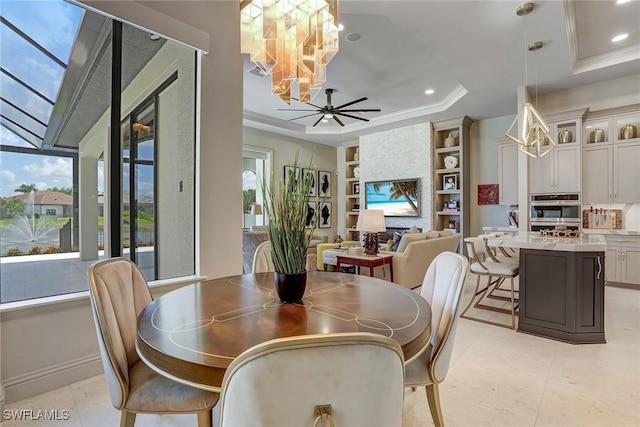 9691 Monteverdi Way, Fort Myers, FL 33912 - dining space with a chandelier, built in features, a tray ceiling, crown molding, and recessed lighting