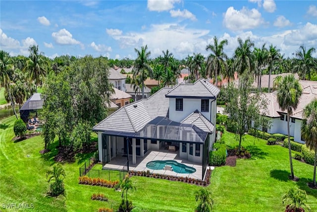 9691 Monteverdi Way, Fort Myers, FL 33912 - back of house featuring a patio, an outdoor pool, a yard, and a residential view