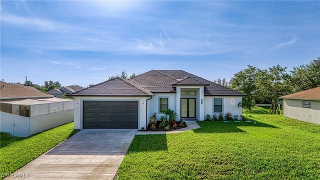807 Hamilton Ave, Lehigh Acres, FL 33972 - view of front of property with an attached garage, driveway, and stucco siding