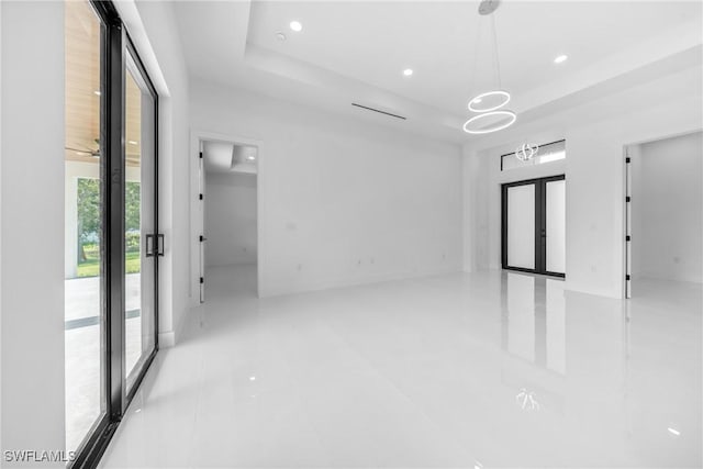 807 Hamilton Ave, Lehigh Acres, FL 33972 - spare room featuring french doors, a raised ceiling, and recessed lighting
