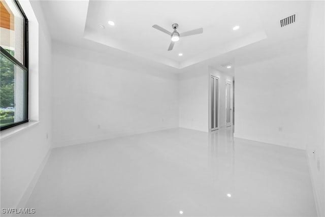 807 Hamilton Ave, Lehigh Acres, FL 33972 - spare room featuring a tray ceiling, recessed lighting, and a ceiling fan