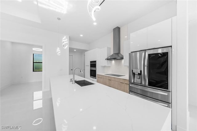 807 Hamilton Ave, Lehigh Acres, FL 33972 - kitchen with appliances with stainless steel finishes, modern cabinets, wall chimney range hood, white cabinets, and pendant lighting
