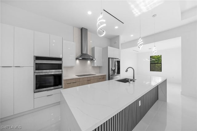 807 Hamilton Ave, Lehigh Acres, FL 33972 - kitchen featuring wall chimney exhaust hood, modern cabinets, appliances with stainless steel finishes, light stone counters, and white cabinetry