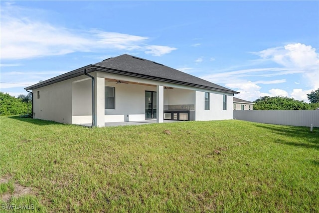 807 Hamilton Ave, Lehigh Acres, FL 33972 - back of house with a ceiling fan and stucco siding