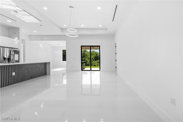 807 Hamilton Ave, Lehigh Acres, FL 33972 - unfurnished living room with light tile patterned flooring, recessed lighting, and a raised ceiling