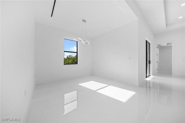 807 Hamilton Ave, Lehigh Acres, FL 33972 - tiled empty room with a chandelier
