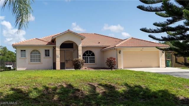 2041 24th Ave NE, Naples, FL 34120 - mediterranean / spanish-style house with stucco siding, an attached garage, a tiled roof, and concrete driveway