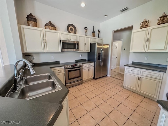 2041 24th Ave NE, Naples, FL 34120 - kitchen featuring appliances with stainless steel finishes, dark countertops, light tile patterned flooring, and recessed lighting