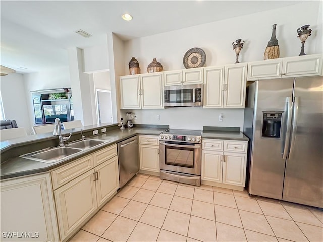 2041 24th Ave NE, Naples, FL 34120 - kitchen featuring stainless steel appliances, dark countertops, light tile patterned floors, a peninsula, and recessed lighting