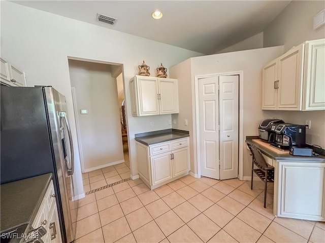 2041 24th Ave NE, Naples, FL 34120 - kitchen featuring stainless steel fridge with ice dispenser, dark countertops, light tile patterned floors, and lofted ceiling