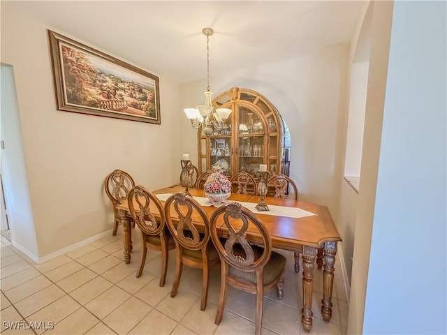 2041 24th Ave NE, Naples, FL 34120 - dining area with a chandelier and light tile patterned floors