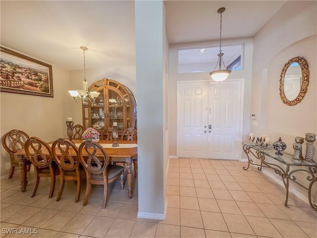2041 24th Ave NE, Naples, FL 34120 - foyer entrance featuring light tile patterned floors and a chandelier