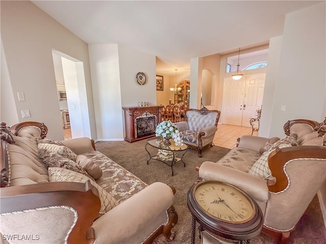 2041 24th Ave NE, Naples, FL 34120 - carpeted living area with a chandelier and baseboards