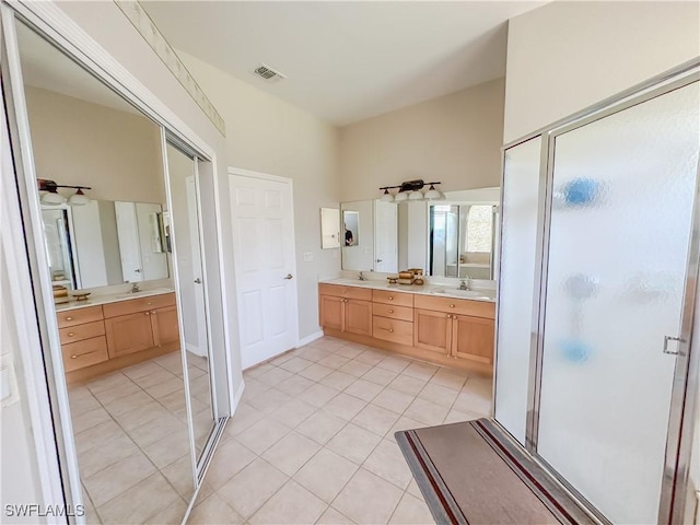 2041 24th Ave NE, Naples, FL 34120 - bathroom with double vanity, a stall shower, and tile patterned floors