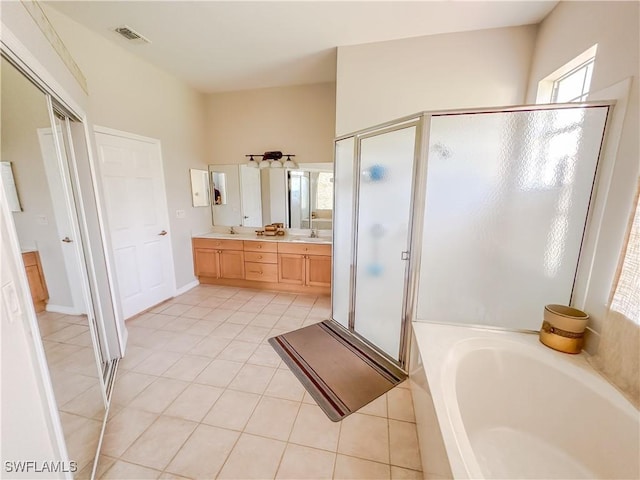 2041 24th Ave NE, Naples, FL 34120 - bathroom featuring a stall shower, a bath, double vanity, and tile patterned flooring