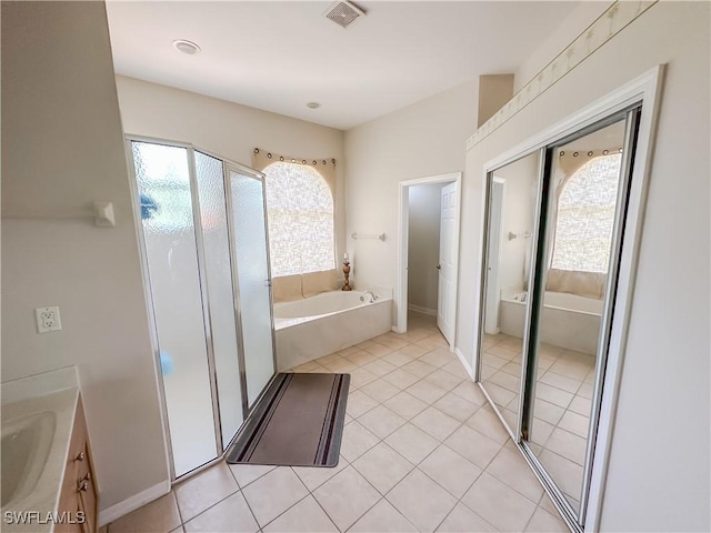 2041 24th Ave NE, Naples, FL 34120 - full bathroom featuring a bath, a shower stall, vanity, and tile patterned flooring