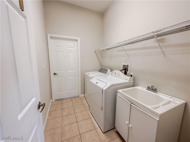 2041 24th Ave NE, Naples, FL 34120 - laundry area with cabinet space, washer and clothes dryer, and light tile patterned flooring