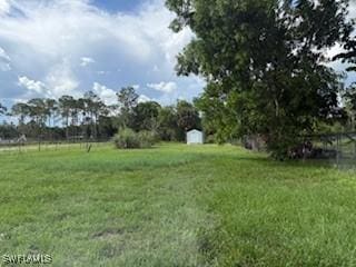 2041 24th Ave NE, Naples, FL 34120 - view of grassy yard featuring a shed